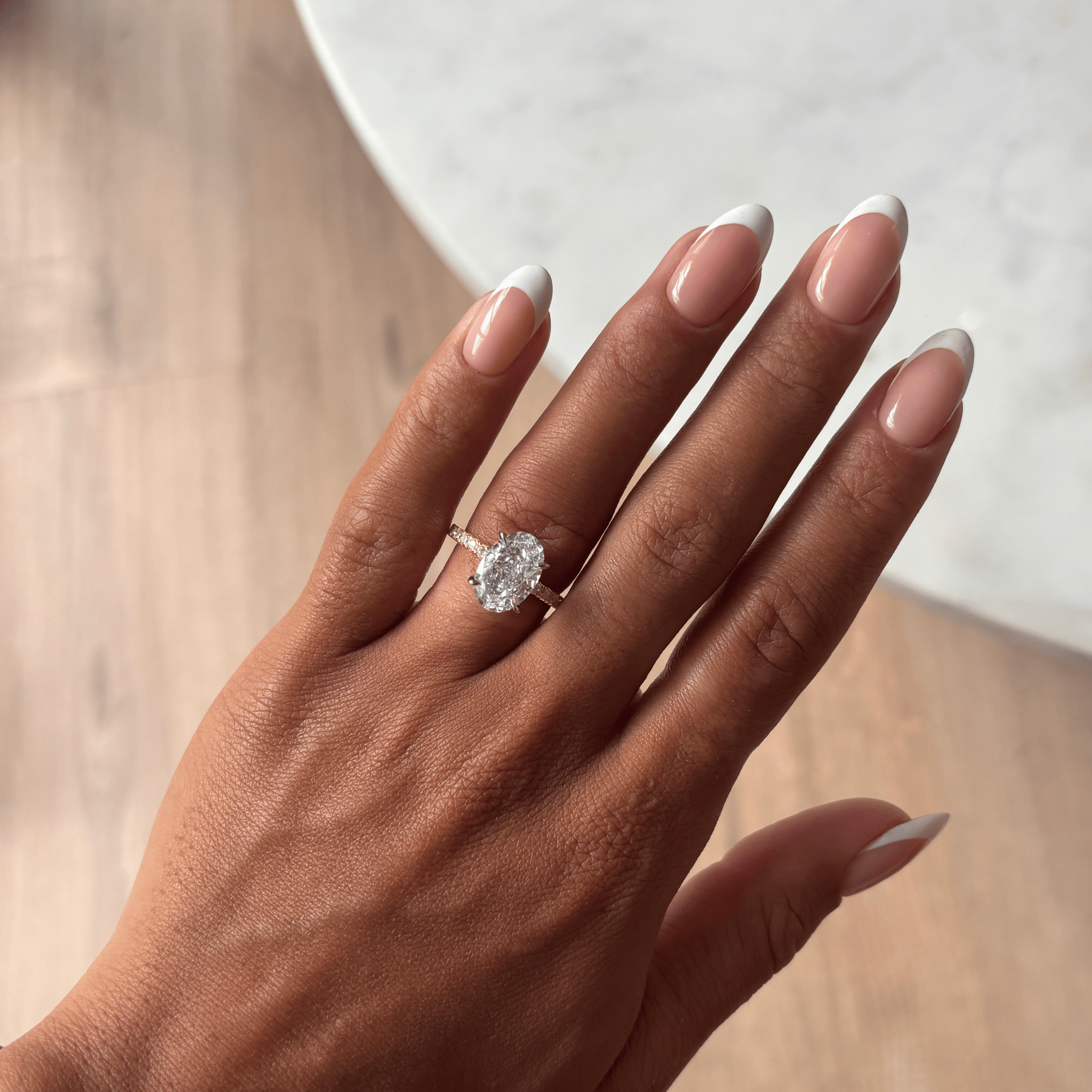 Close‑up detail of half pavé band and rhodium claws on Promise Sparkle Oval Ring -a refined take on wedding band style and promise ring elegance